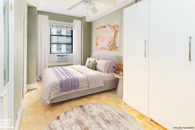 bedroom featuring cooling unit, light parquet floors, and ceiling fan