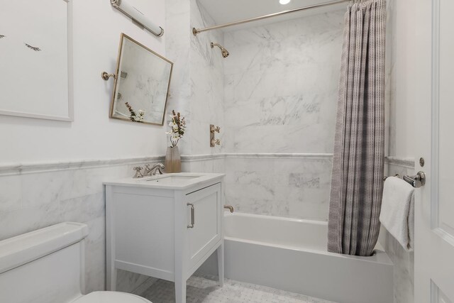 320 E 82nd Street Penthouse, New York City, NY 10028 - full bath with shower / tub combo with curtain, toilet, vanity, a wainscoted wall, and tile walls