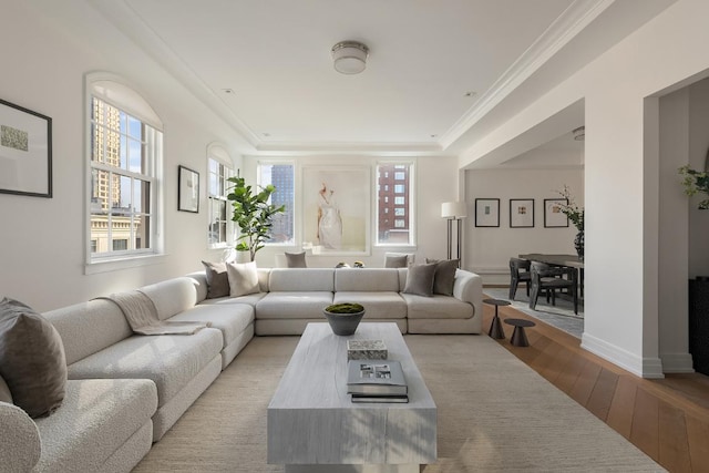 living room with light hardwood / wood-style flooring and ornamental molding