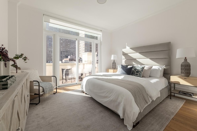 320 E 82nd Street Penthouse, New York City, NY 10028 - bedroom with light wood finished floors and ornamental molding