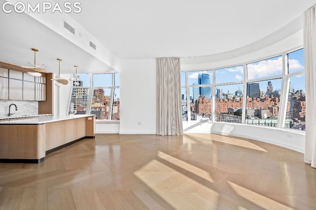 kitchen with plenty of natural light, pendant lighting, and tasteful backsplash