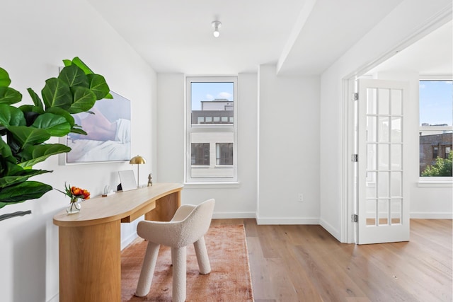 home office with wood finished floors and baseboards