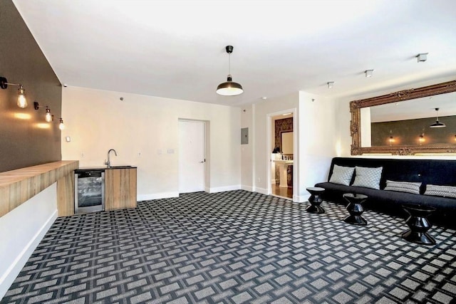 misc room with sink, dark carpet, and beverage cooler