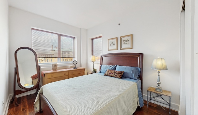 bedroom with dark hardwood / wood-style flooring