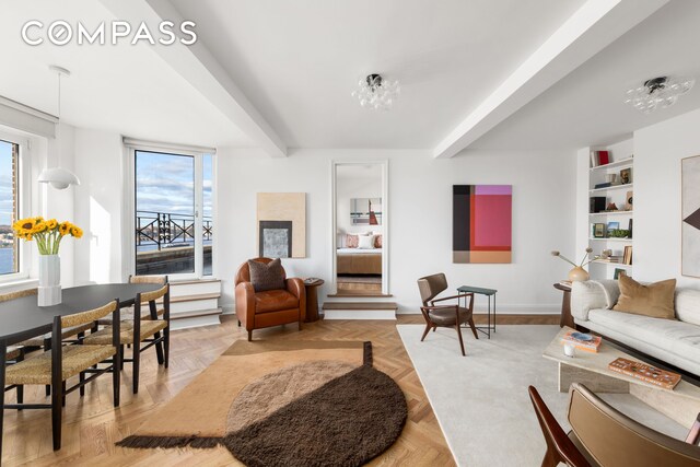 living room featuring light parquet flooring and beam ceiling