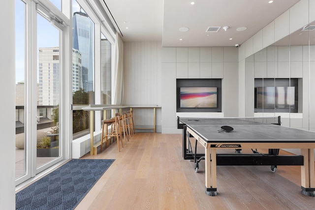 playroom featuring visible vents and light wood finished floors