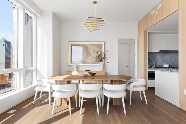 dining area with a chandelier and wood finished floors