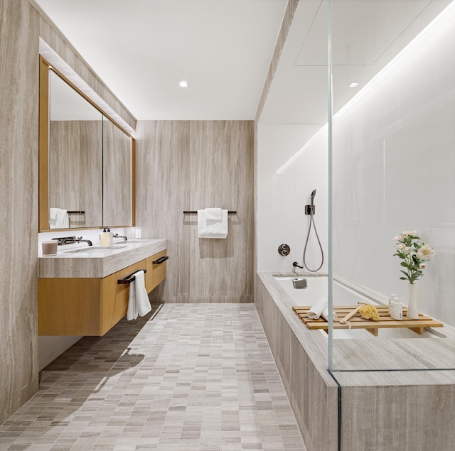 bathroom with tiled shower and vanity