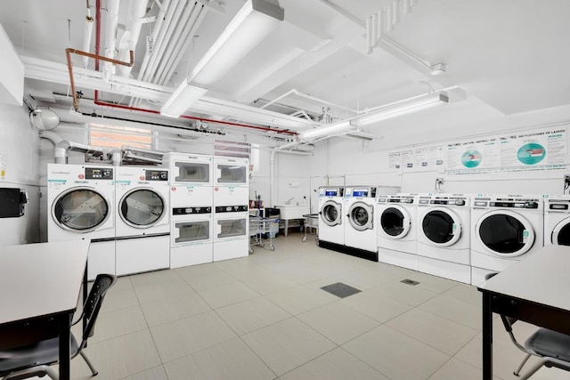 laundry area with light tile patterned flooring and separate washer and dryer