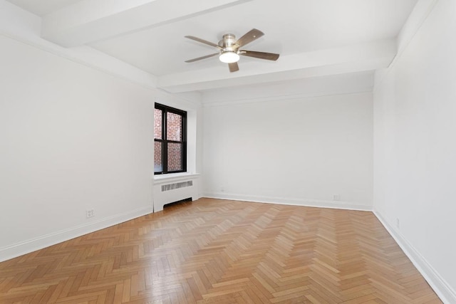 spare room featuring radiator, ceiling fan, beamed ceiling, and light parquet floors