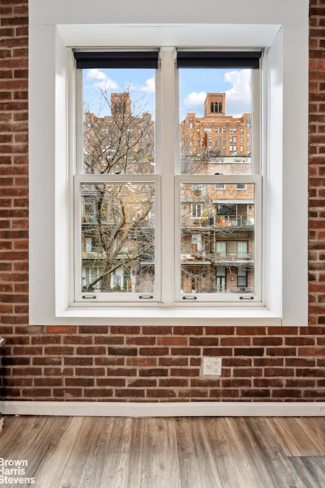 details featuring a city view, baseboards, and wood finished floors