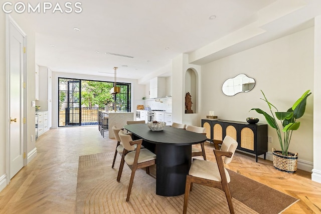 dining space with light parquet flooring