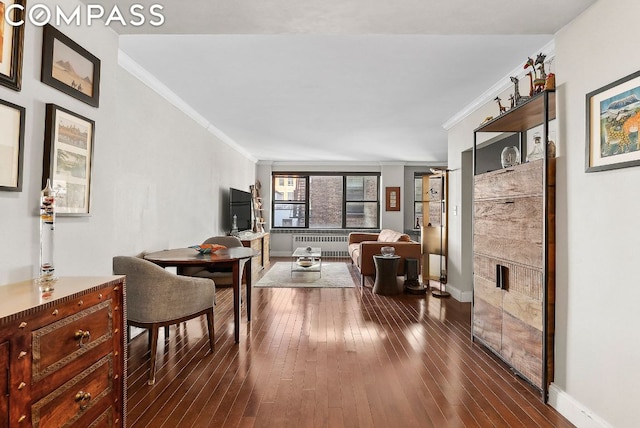 living room with radiator heating unit, dark hardwood / wood-style flooring, and ornamental molding