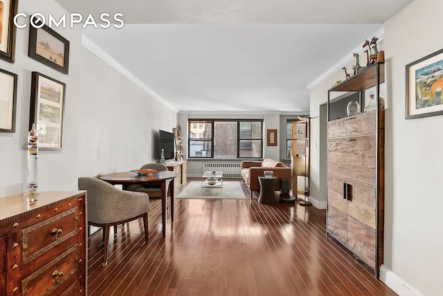 interior space featuring baseboards, dark wood-type flooring, ornamental molding, and radiator heating unit