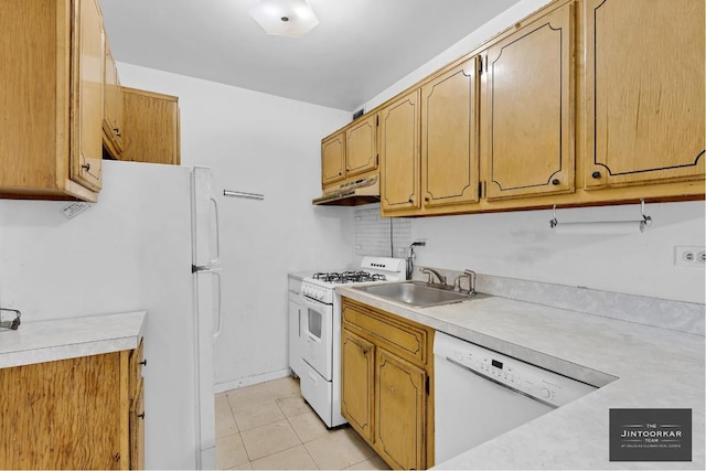 kitchen featuring sink, light tile patterned floors, and white appliances