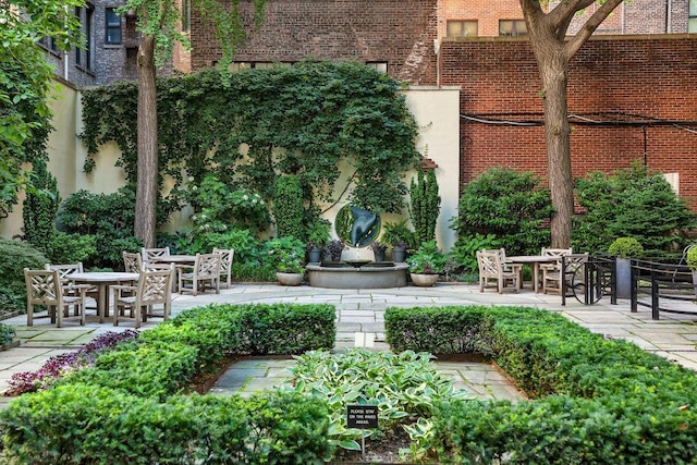 view of community with a patio and outdoor dining space