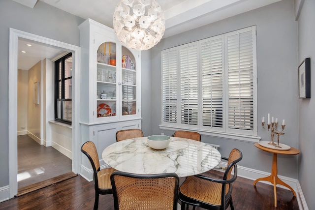 dining room with an inviting chandelier, baseboards, and dark wood-style flooring