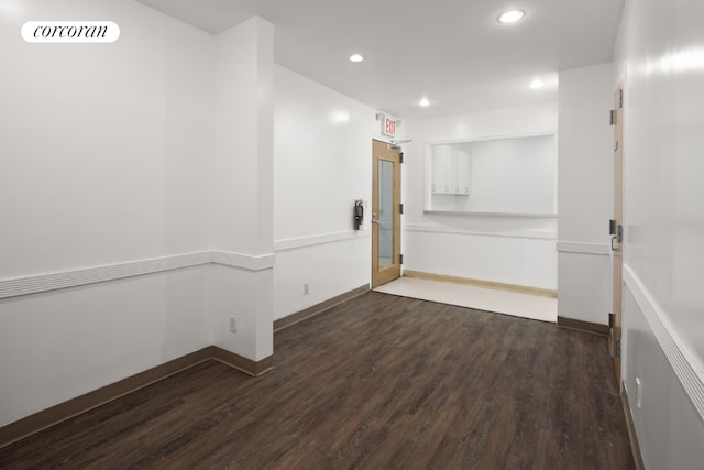 unfurnished room with dark hardwood / wood-style flooring