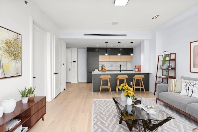 living room featuring light wood-type flooring and sink