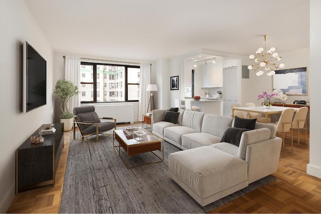 living room with a chandelier and dark parquet floors