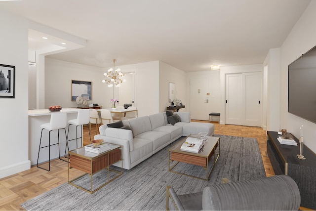 living area with recessed lighting, baseboards, and an inviting chandelier