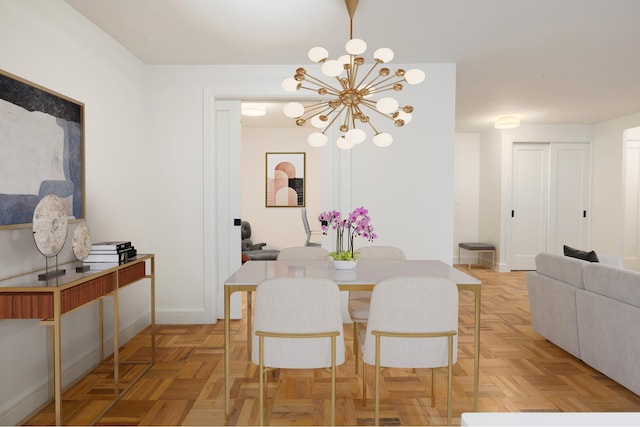 dining area with baseboards and a chandelier