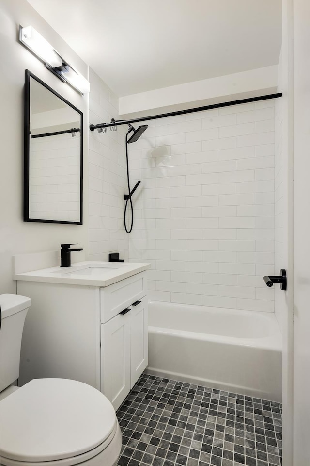 bathroom featuring toilet, vanity, and shower / tub combination