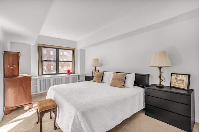 carpeted bedroom featuring radiator