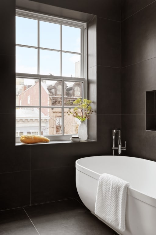 bathroom featuring plenty of natural light, a bathing tub, and tile patterned floors