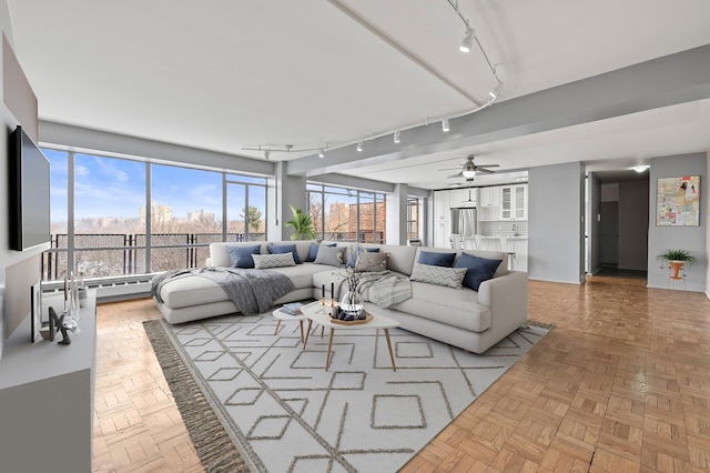 living room with rail lighting and ceiling fan