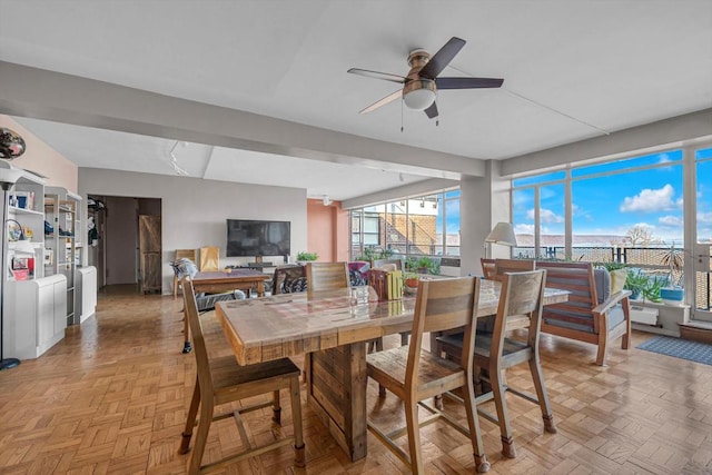 dining area with ceiling fan, light parquet floors, and plenty of natural light