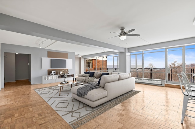 living room featuring a baseboard heating unit and ceiling fan