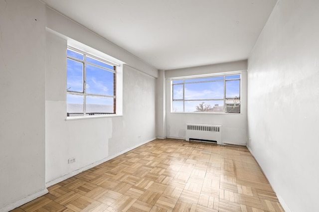 unfurnished room featuring radiator heating unit