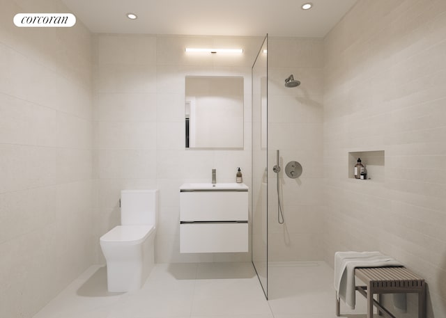 bathroom featuring tile walls, a walk in shower, vanity, tile patterned floors, and toilet