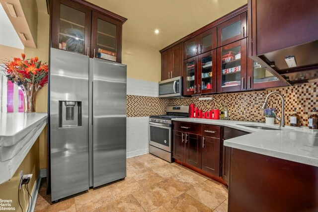 kitchen featuring stainless steel appliances, sink, and backsplash