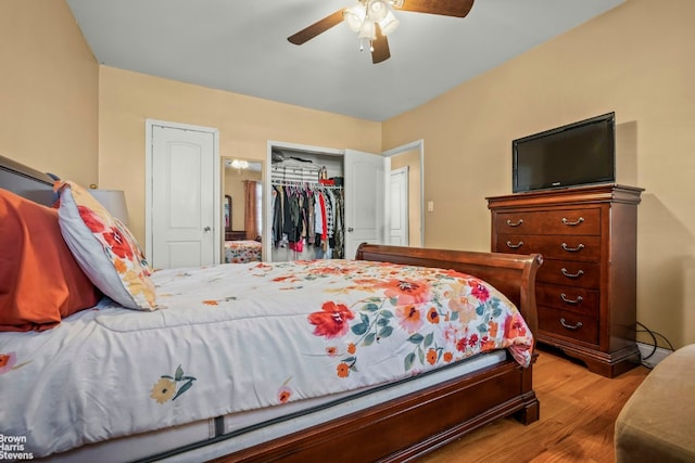 bedroom with ceiling fan, light hardwood / wood-style floors, and a closet