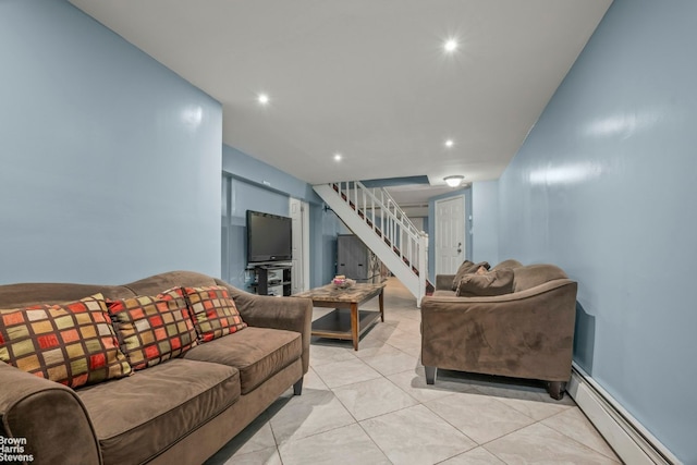 living room featuring a baseboard heating unit and light tile patterned floors