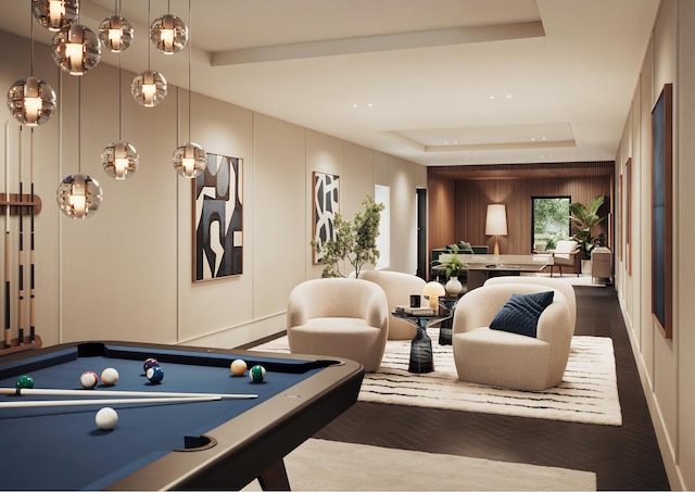 playroom featuring a tray ceiling, a decorative wall, and pool table