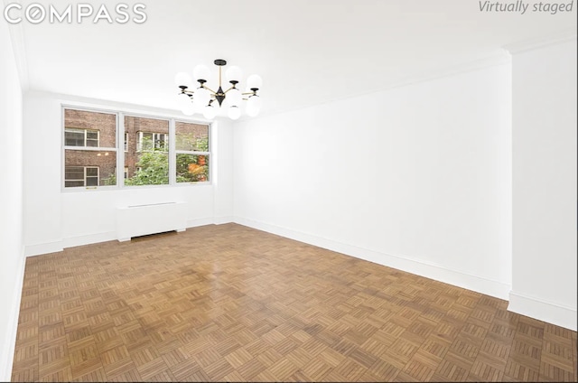 unfurnished room with crown molding, parquet flooring, radiator heating unit, and a notable chandelier