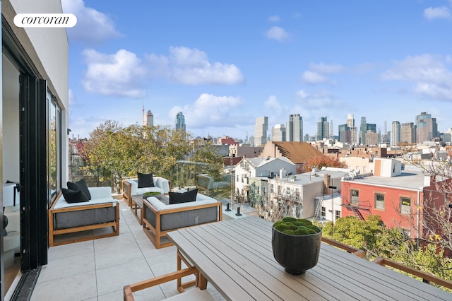 balcony with a view of city and an outdoor hangout area