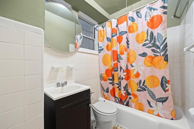 full bathroom with toilet, vanity, tile walls, and shower / bathtub combination with curtain