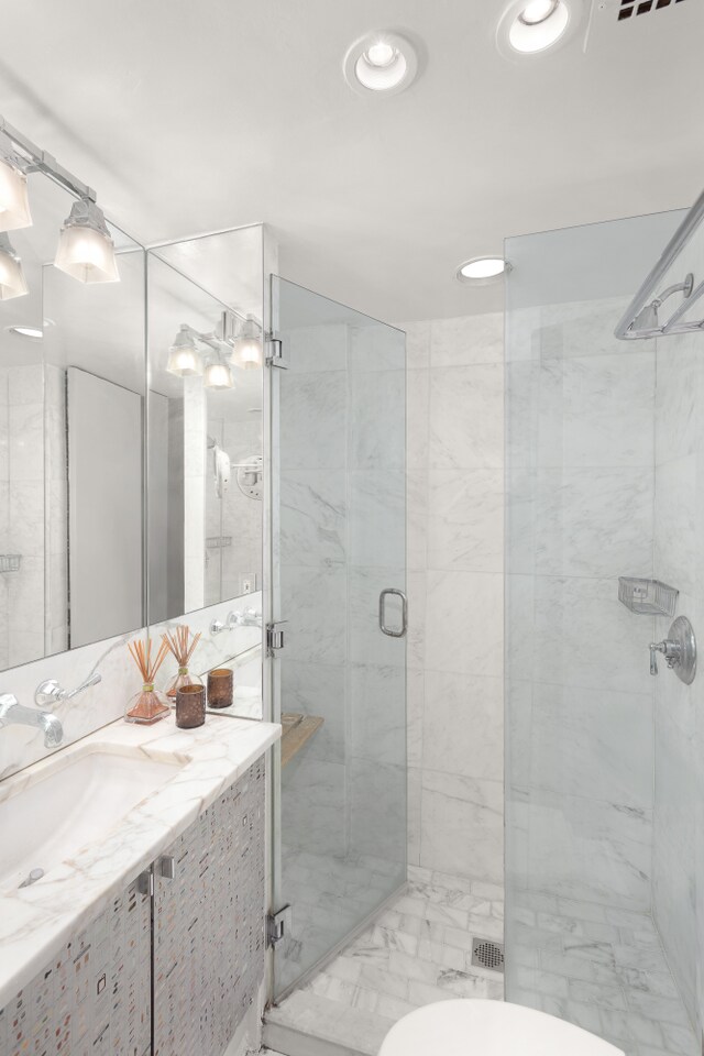 bathroom featuring walk in shower, vanity, and toilet