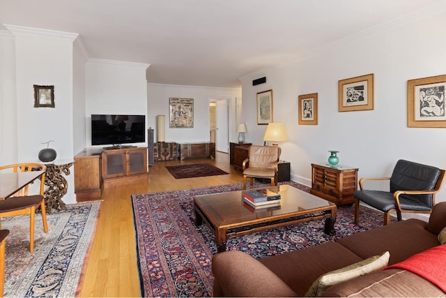 living room with crown molding and light hardwood / wood-style flooring