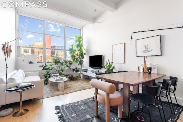 office area with hardwood / wood-style flooring and beam ceiling