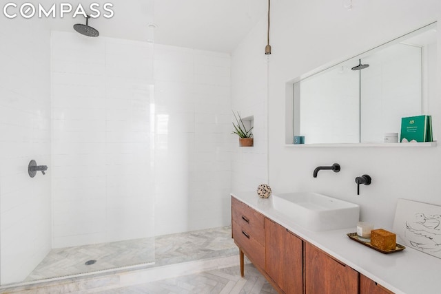 bathroom with walk in shower and vanity