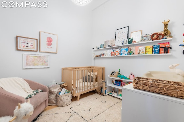 bedroom featuring a crib