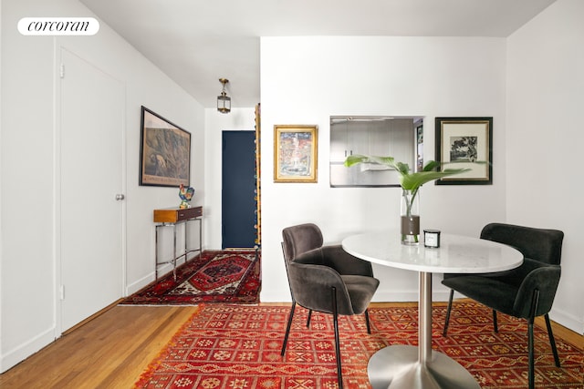 dining space with wood finished floors and baseboards