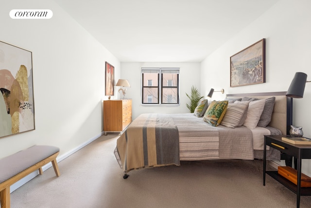 carpeted bedroom featuring baseboards