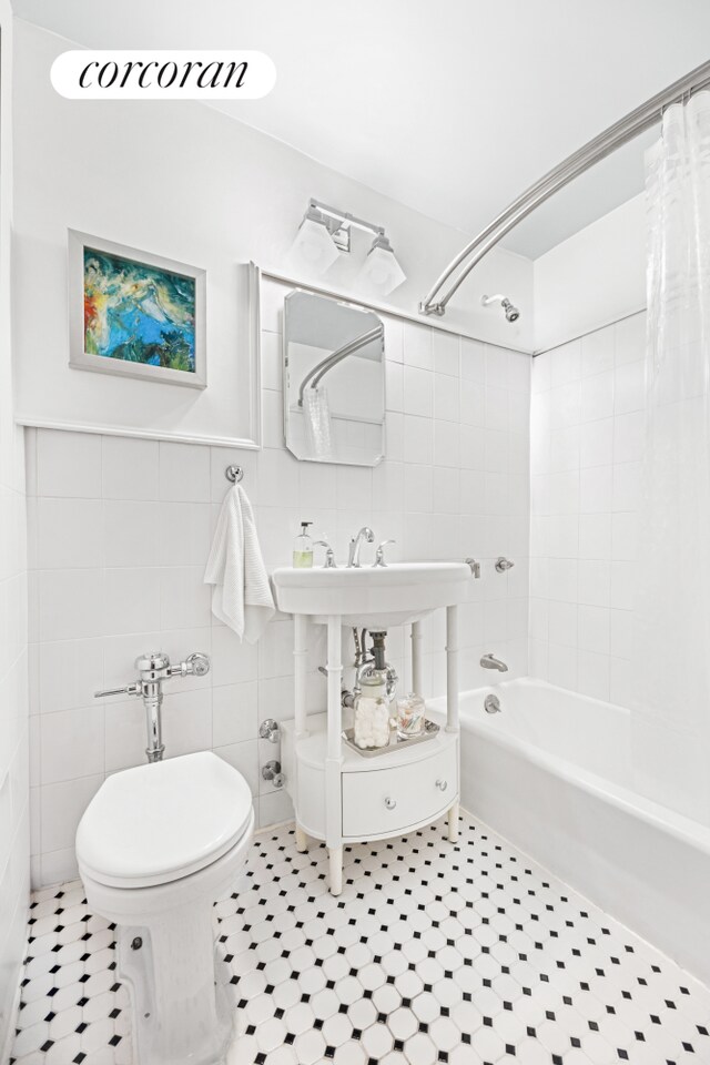 337 E 50th St Unit 3E, New York City, NY 10022 - full bathroom featuring shower / bathtub combination with curtain, tile walls, tile patterned flooring, and toilet