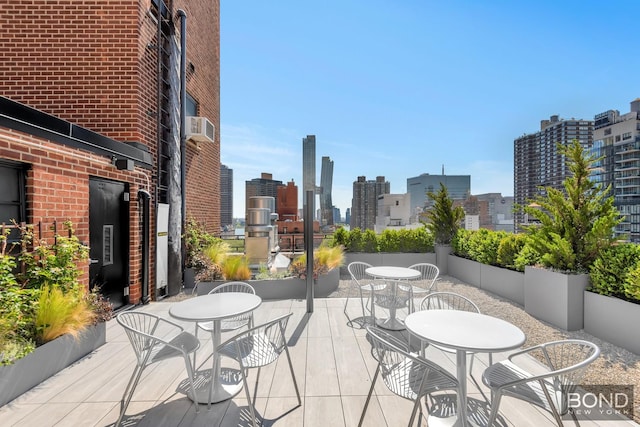 view of patio / terrace with outdoor dining area and a city view